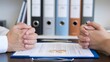 © TimeaPeter - Couple's Hands on Divorce Papers with Wedding Rings During Legal Separation Meeting at Attorney Office