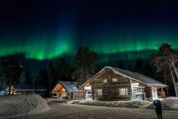 northern lights in lapland inari nellin lake forest wooden hut