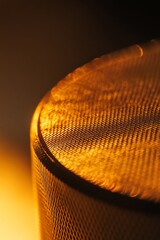 Aufkleber - Close-up of a gold metallic textured surface with a circular shape and subtle light reflection.