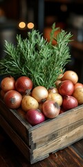 Wooden crate filled with assorted onions and fresh rosemary.