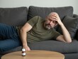 © Kanitta - a man lying on the sofa because of a fever