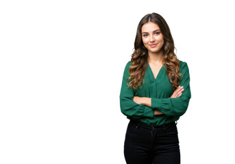 a confident young woman with wavy brown hair in a green blouse and black pants, standing with arms c