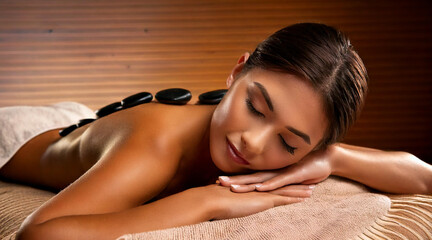 Wall Mural - model lying on a spa bed during a stone massage. 