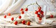 © Anelya - Fresh cherry tomatoes branch resting on a glass with additional tomatoes scattered on a wooden surface