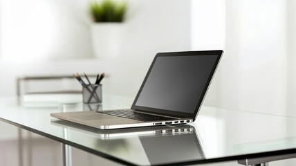 Poster - A sleek laptop sits on a glass desk, surrounded by a minimalistic workspace and a small potted plant, reflecting a modern and organized aesthetic.
