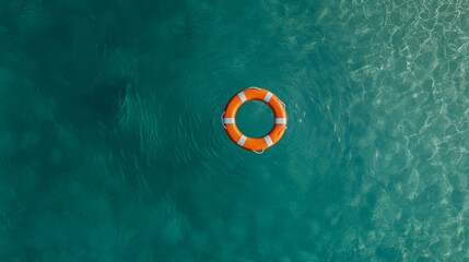 Poster - Orange lifebuoy floating on calm turquoise water surface with light reflections, providing safety and rescue during summer holidays at a tropical resort