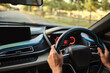 © photopk - photograph of steering wheel and console of a car riding on the freeway in sunrise  shot with vary shallow focusing that keep most of photograph out of focus blurred