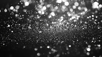 Poster - Sparkling silver and white bokeh lights on a dark background for festive winter card invitations or holiday celebrations.