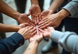 © puruan - Hands gathered in unity to support a common goal during a group activity