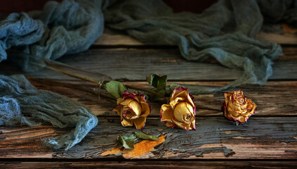 Wall Mural - A small bouquet of dried roses on a dark background.