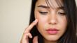 © Litan - Woman touching her face close up portrait