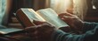© Nattapat - A closeup of a handsome man s hands praying on an open Bible, soft window light illuminating the scene, conveying peace, hope, and love, morning devotion moment