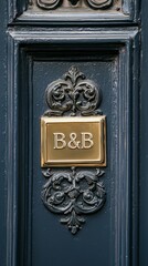 Wall Mural - Elegant Door Detail: A close-up captures the intricate embellishments of a classic blue door, featuring a decorative brass plaque with the inscription 