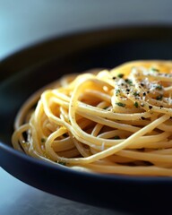 Wall Mural - A delicious bowl of spaghetti, elegantly presented with a sprinkle of cheese and herbs.