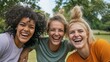 © liliyabatyrova - Three happy female friends share smiles and laughter while volunteering in a community park. Their enthusiasm creates a warm atmosphere on this bright, sunny day