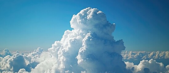 Poster - Aerial perspective of majestic cumulus clouds against a vibrant blue sky creating an inspiring backdrop for promotional content.