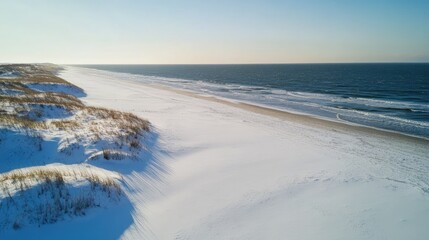 Aufkleber - Aerial view of a winter white sand beach alongside a calm ocean with a clear sky and ample space for text placement