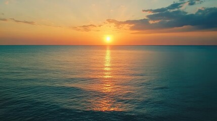 Aufkleber - Aerial view of serene turquoise ocean waves reflecting golden sunset light on calm waters during a picturesque evening sky