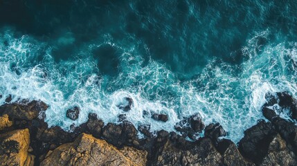 Leinwandbilder - Aerial view of ocean waves crashing on rocky shore with clear space for text and branding placement in natural coastal setting