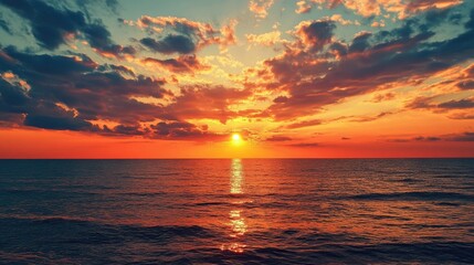 Poster - Stunning sunset over the tranquil sea with vibrant colors and dramatic clouds reflecting in the water creating a serene coastal atmosphere
