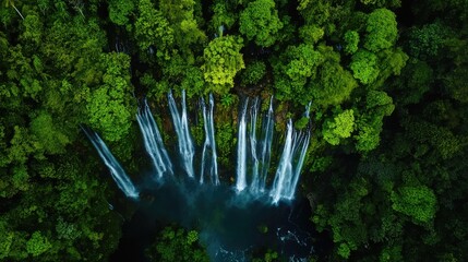 Poster - Aerial view of cascading waterfalls surrounded by lush green foliage showcasing the serene beauty of nature with space for text inclusion