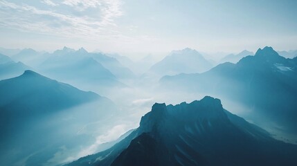 Poster - Misty mountain range at sunrise, aerial view.