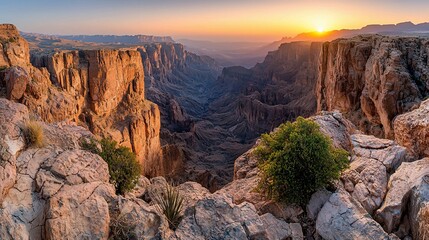 Poster - Sunset over a vast canyon landscape, viewed from a rocky precipice.