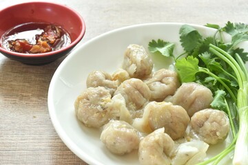 Wall Mural - steamed fish dumpling with parsley and spring onion on plate dipping spicy sour sauce 