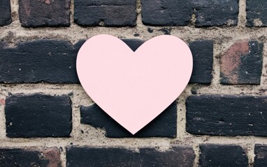 Poster - A pink heart shape against a textured brick wall, symbolizing love and affection in a unique urban setting.