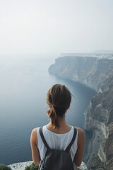 Wall Mural - Serene landscape showcases person gazing at calm waters and clif