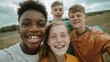 © Artinun - Diverse group of cheerful teenagers enjoying a sunny day outdoors, showcasing friendship and happiness in a rural landscape with lush greenery in the background