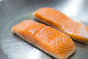 Wall Mural - Fresh salmon fillets cooking on hot pan