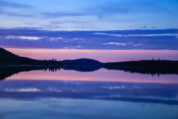 Wall Mural - a beautiful lake with a purple sky in the background