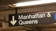 © Dogora Sun - New York subway station interior, Manhattan text sign. Underground metropolitan. United States metro transport navigation. Information signage public passenger railway. Downtown and Queens direction.