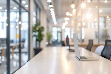 Poster - Modern office workspace with laptops and blurred background.