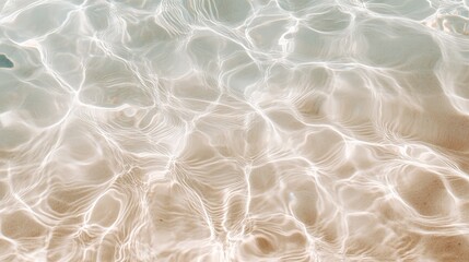 Poster - Sunlight streaming down, illuminating crystal clear water as gentle ripples dance over golden sand, creating a captivating and mesmerizing natural pattern along the tranquil beach