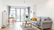 © GMeta - Modern living room with gray sofa vibrant pillows flowers and cozy throw blanket by sunny windows