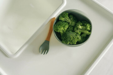 Wall Mural - Broccoli in a plate, first complementary food using the blw method