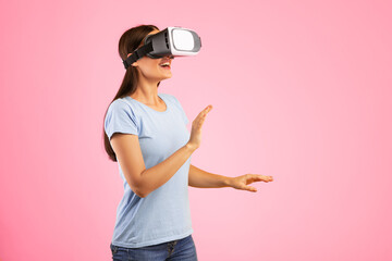Poster - Excited woman using VR headset and experiencing virtual reality, yellow studio wall