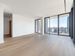 © Bouchra - A large open living room with a view of the city