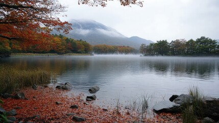 Poster - Beautiful autumn colors and red leaves surrounding Lake Kawaguchiko, with fog drifting over the water and Mountain Fuji towering in the distance.