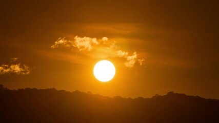 Wall Mural - Time lapse of dramatic sunrise with orange sky in a cloudy day.