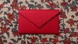 © Chanagun - A vibrant red envelope rests on a floral patterned background. This image captures the essence of communication and thoughtful gestures, perfect for invitations or personal notes.
