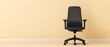© padungsak - A sleek black office chair positioned against a plain beige wall, highlighting a minimalist workspace.