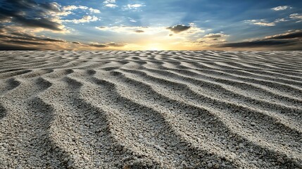 Wall Mural - a serene landscape featuring rippled sand dunes under a dramatic sky at sunset, creating a tranquil 