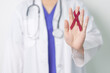 © Jo Panuwat D - Doctor with Burgundy Red Ribbon for March multiple myeloma Cancer and December World Aids Day Awareness month. Healthcare and world cancer day concept