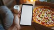 © Ashi - Person holding smartphone with blank screen above pizza in cardboard box, concept of online food ordering and delivery, artificial intelligence-generated visual