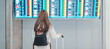 © Jo Panuwat D - Young woman hand holding luggage handle before checking flight time in airport, Transport, insurance, travel and vacation concepts