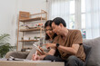 © wichayada - Elderly Couple Engaged in Financial Planning at Home with Documents and Calculator on Table