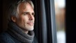 © ngamaz - Man looking out window, winter day, pensive mood, home interior, for articles